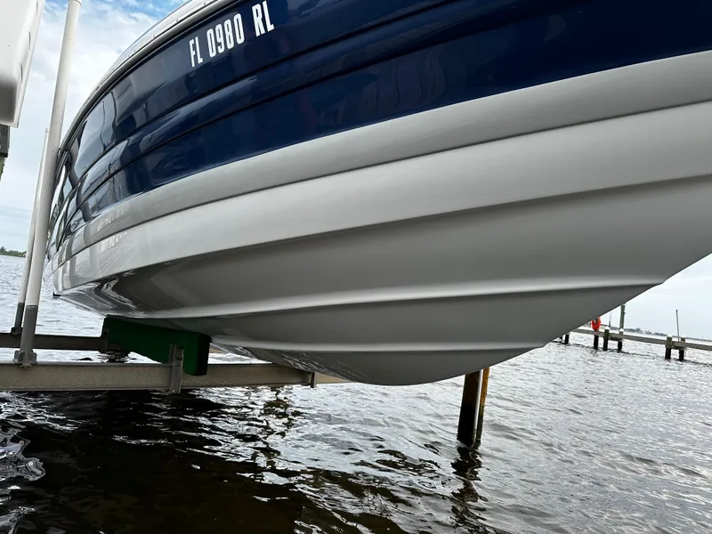 Slide: The Image of 2016 Crownline 285 SS boat on a lift over water. - 7