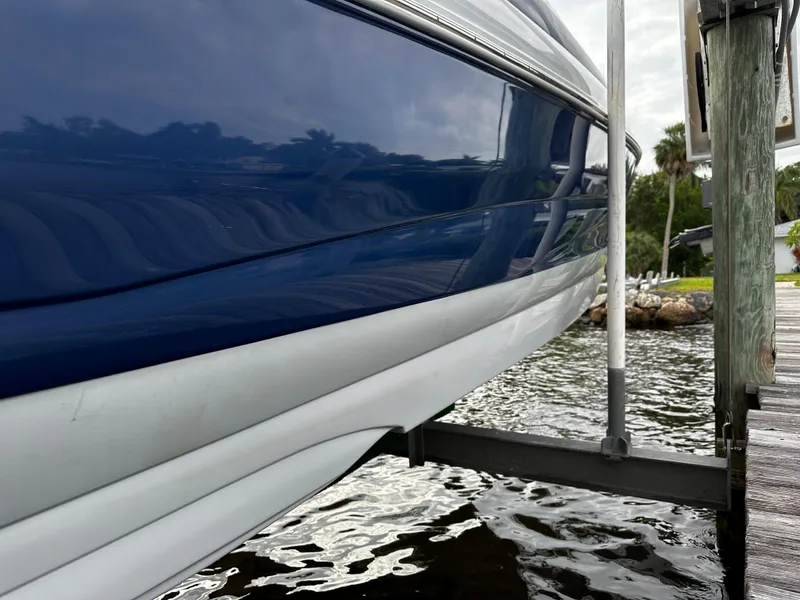 Slide: The Image of 2016 Crownline 285 SS boat docked by the water. - 8