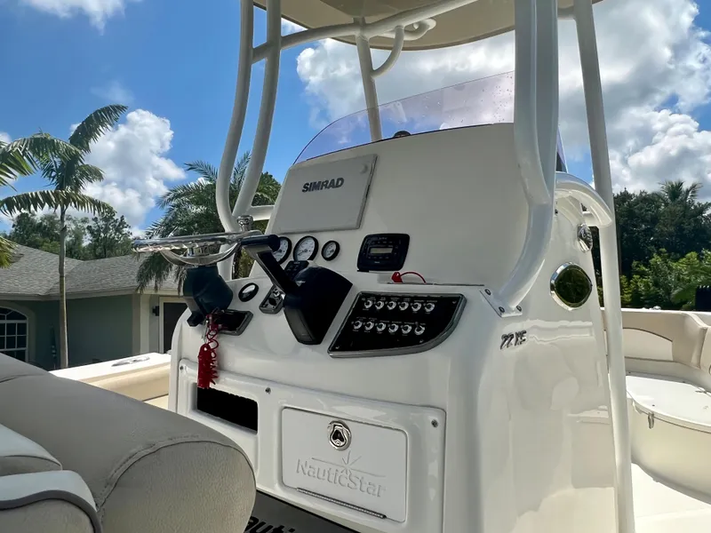 Slide: The Image of 2018 NauticStar 22 XS boat console with steering wheel and controls. - 10