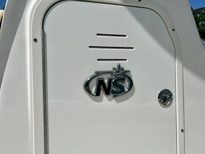 Slide: The Image of 2018 NauticStar 22 XS boat emblem and compartment door. - 11