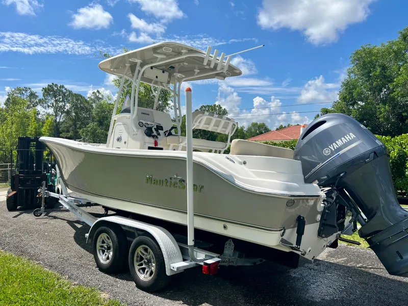 Slide: The Image of 2018 NauticStar 22 XS boat on trailer with Yamaha outboard motor. - 17