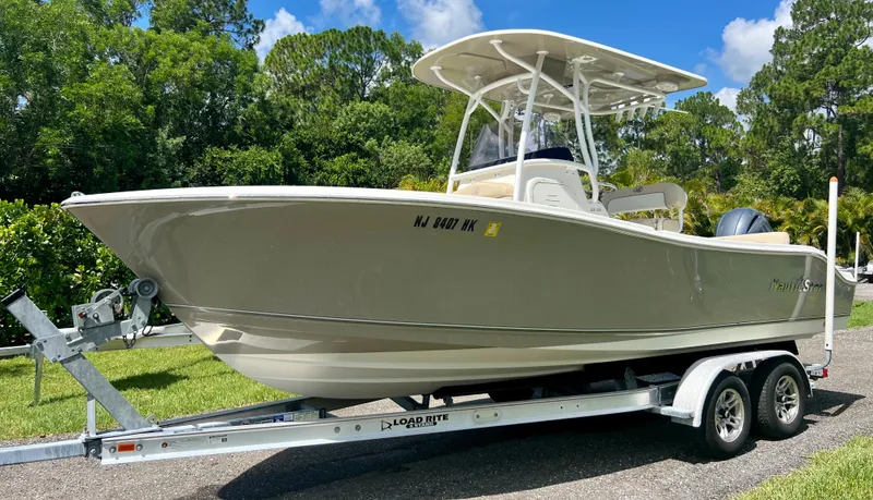 Slide: The Image of 2018 NauticStar 22 XS boat on trailer, side view, outdoors. - 2