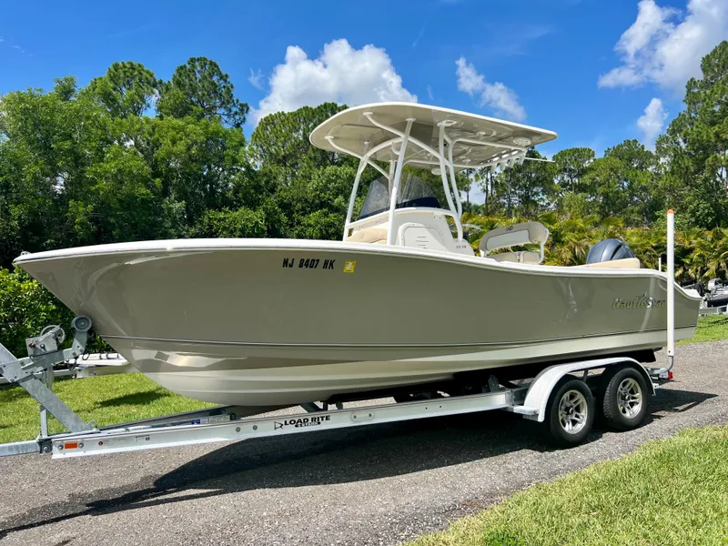Slide: The Image of 2018 NauticStar 22 XS boat on a trailer in a sunny outdoor setting. - 4
