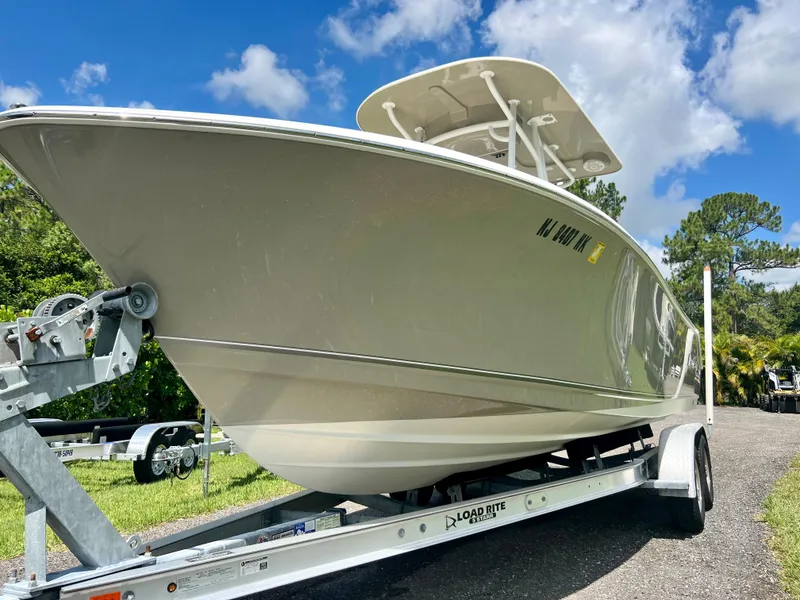 Slide: The Image of 2018 NauticStar 22 XS boat on a trailer under a blue sky. - 5