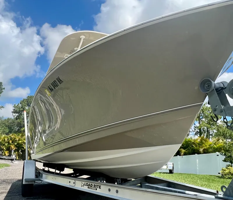 Slide: The Image of 2018 NauticStar 22 XS boat on Load Rite trailer under blue sky. - 6