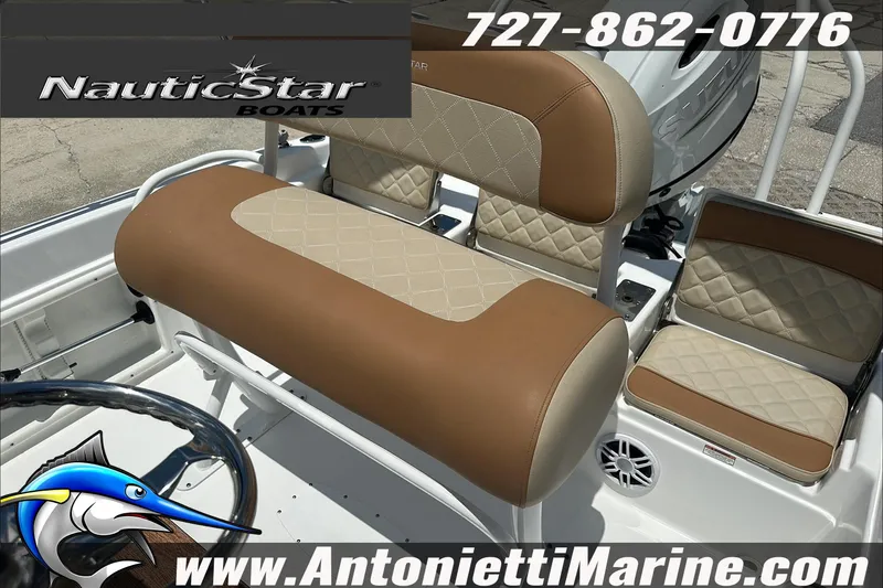 Slide: The Image of 2024 NauticStar 211 Hybrid boat interior with tan and cream seating, featuring logo and contact details. - 15