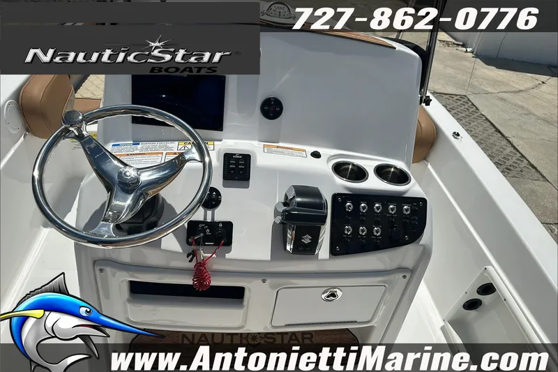 Slide: The Image of 2024 NauticStar 211 Hybrid boat dashboard with steering wheel and controls. - 16