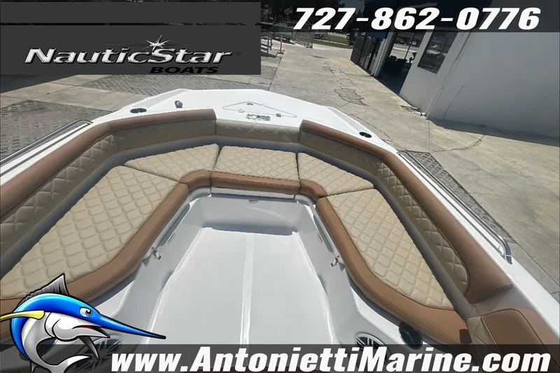 Slide: The Image of 2024 NauticStar 211 Hybrid boat with tan seating, displayed at Antonietti Marine. - 22