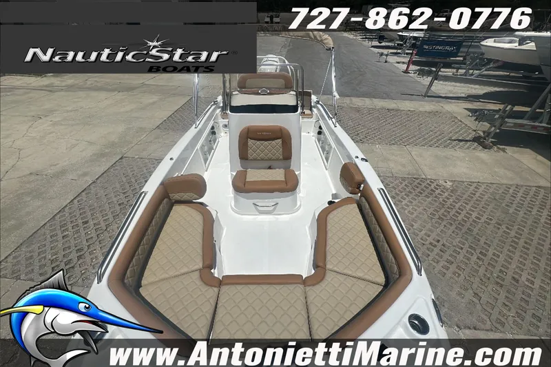 Slide: The Image of 2024 NauticStar 211 Hybrid boat with tan seating, displayed at Antonietti Marine. - 27