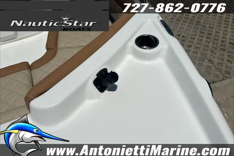 Slide: The Image of 2024 NauticStar 211 Hybrid boat interior with cup holders and seating, Antonietti Marine branding. - 28