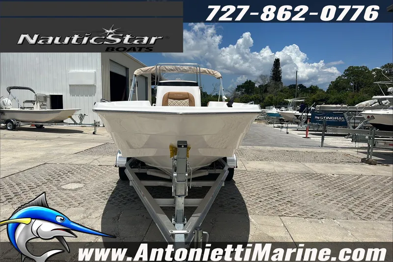 Slide: The Image of 2024 NauticStar 211 Hybrid boat on trailer at Antonietti Marine dealership. - 3