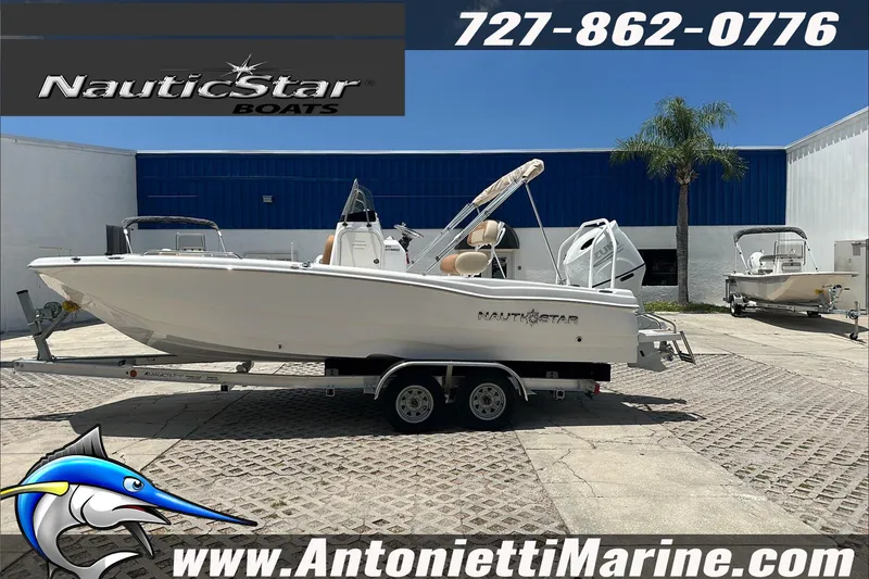 Slide: The Image of 2024 NauticStar 211 Hybrid boat on trailer at Antonietti Marine dealership. - 5