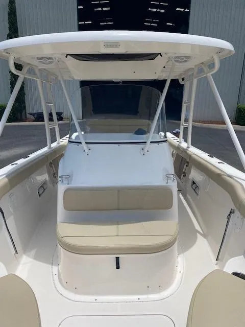 Slide: The Image of 2017 Pursuit S 280 Sport boat with beige seating and white canopy. - 10
