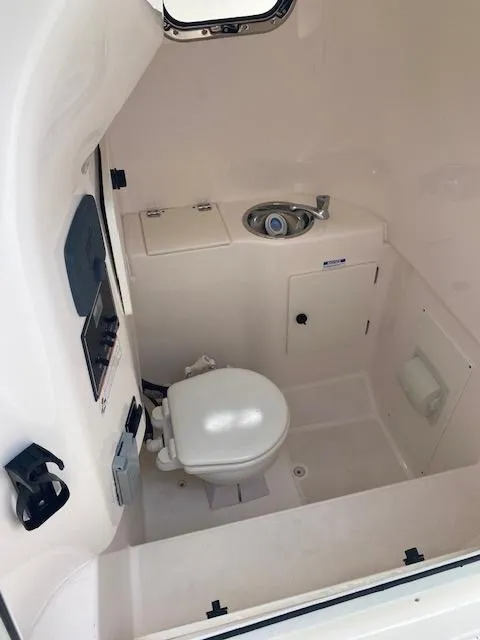 Slide: The Image of 2017 Pursuit S 280 Sport boat interior bathroom with toilet and sink. - 11