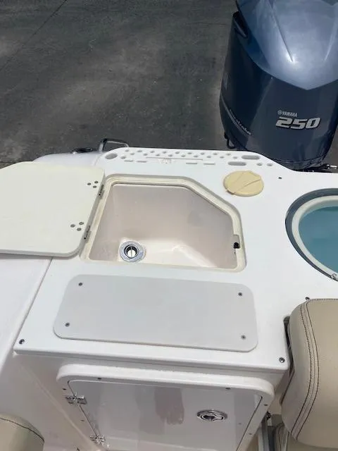 Slide: The Image of 2017 Pursuit S 280 Sport boat with Yamaha 250 engine, featuring a sink and storage area. - 13