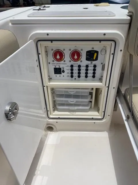Slide: The Image of Control panel of a 2017 Pursuit S 280 Sport boat with open access door. - 14