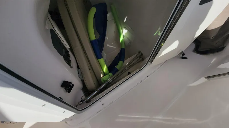 Slide: The Image of 2017 Pursuit S 280 Sport boat storage compartment with snorkeling gear. - 17
