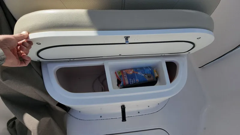 Slide: The Image of 2017 Pursuit S 280 Sport boat storage compartment with snacks and drink. - 19