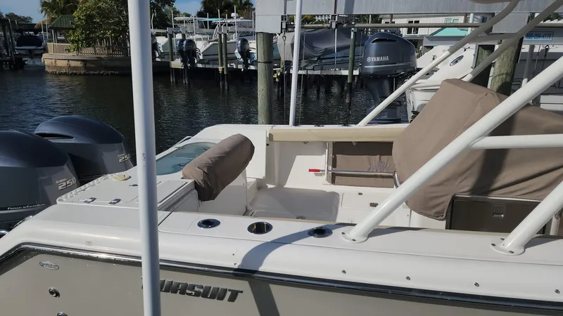Slide: The Image of 2017 Pursuit S 280 Sport boat docked at marina, featuring dual engines. - 25