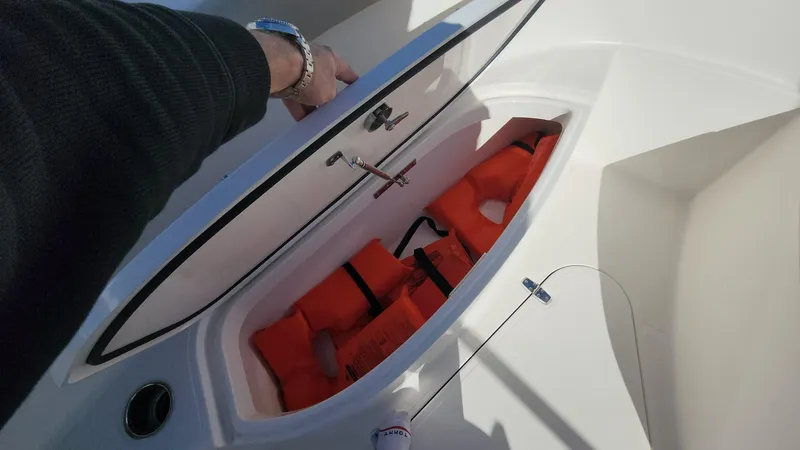 Slide: The Image of 2017 Pursuit S 280 Sport boat storage with orange life jackets. - 27