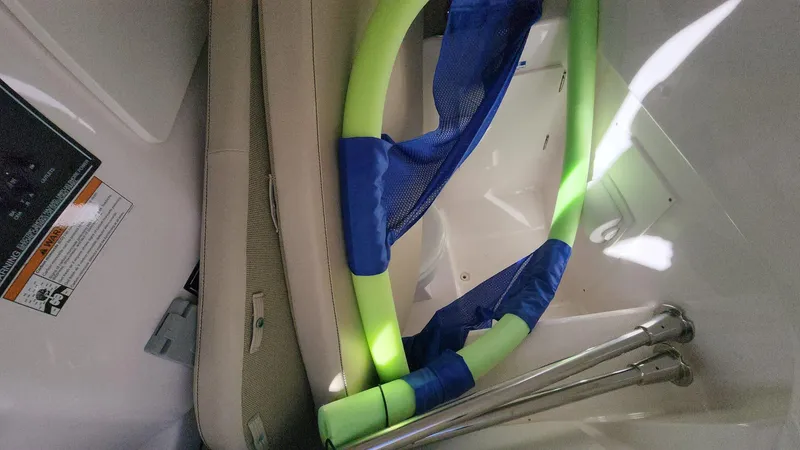 Slide: The Image of Interior storage of 2017 Pursuit S 280 Sport boat with pool noodles and metal rods. - 29