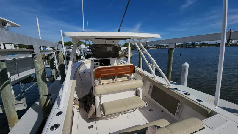 Slide: The Image of 2017 Pursuit S 280 Sport boat docked by the water on a sunny day. - 30