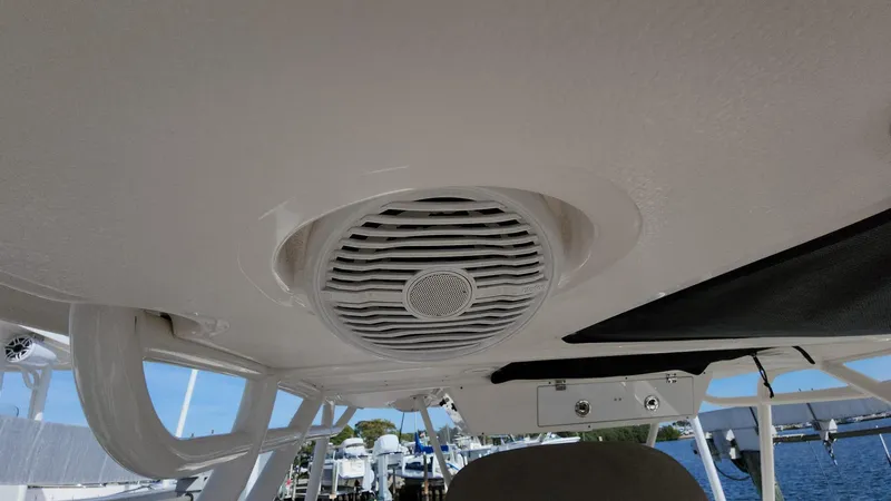 Slide: The Image of 2017 Pursuit S 280 Sport boat speaker on ceiling, marina background. - 33