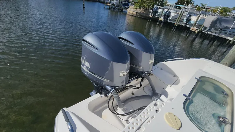 Slide: The Image of 2017 Pursuit S 280 Sport boat with dual Yamaha outboard motors on calm water. - 40