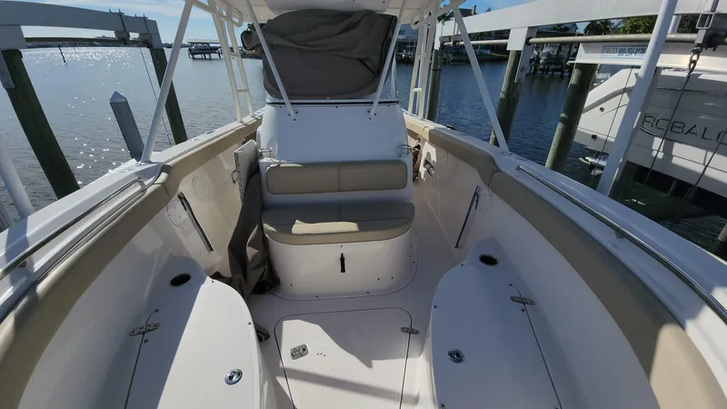 Slide: The Image of 2017 Pursuit S 280 Sport boat interior with seating, docked by the water. - 45