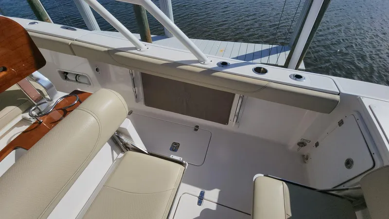 Slide: The Image of 2017 Pursuit S 280 Sport boat interior with beige seating and rod holders. - 47