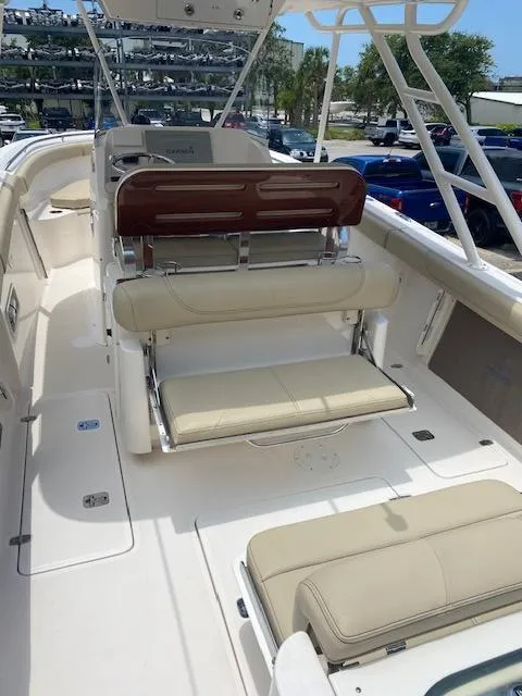 Slide: The Image of 2017 Pursuit S 280 Sport boat interior with beige seating and helm station. - 8
