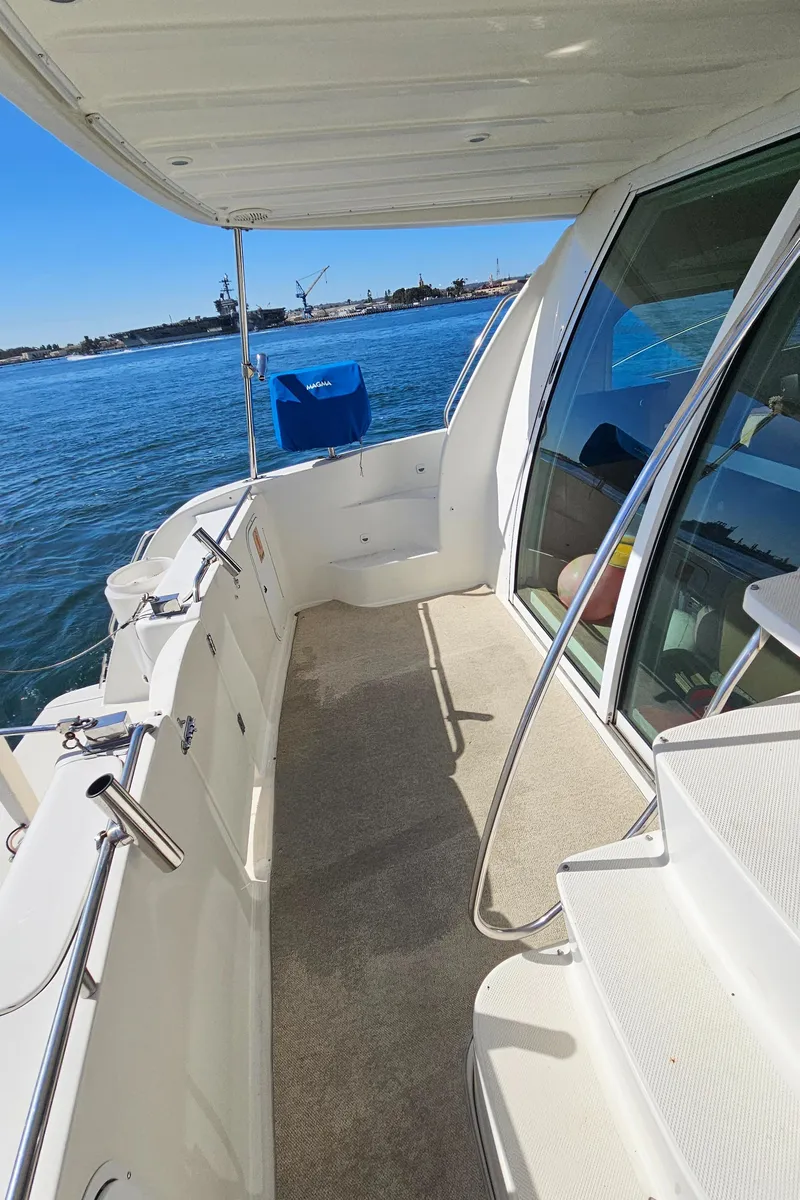 Slide: The Image of Deck of a 2002 Maxum 4600 SCB Limited Edition boat by the water. - 21