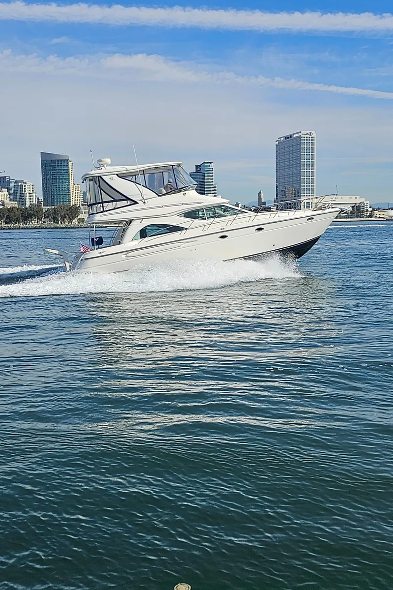 Slide: The Image of 2002 Maxum 4600 SCB Limited Edition cruising on water near city skyline. - 48