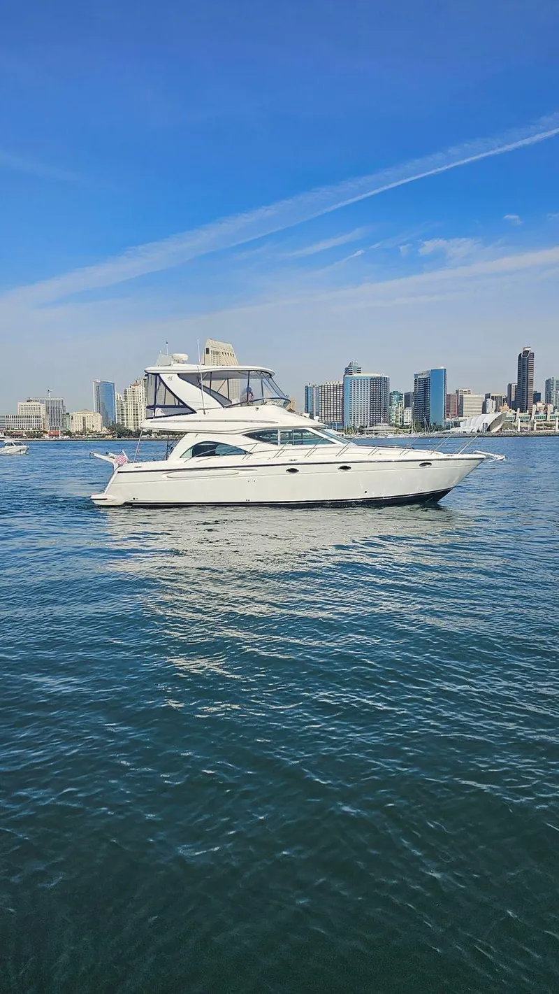Slide: The Image of 2002 Maxum 4600 SCB Limited Edition yacht on water with city skyline. - 5
