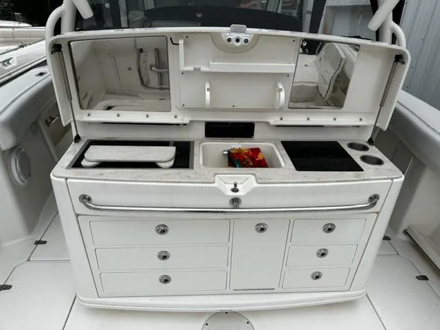Slide: The Image of 2014 Boston Whaler 370 Outrage boat galley with storage drawers and sink. - 4