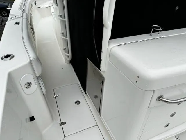 Slide: The Image of 2014 Boston Whaler 370 Outrage boat deck with storage compartments and seating. - 7