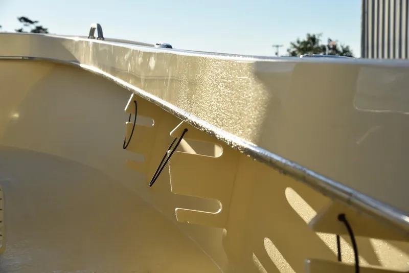 Slide: The Image of 2024 Jones Brothers Cape Fisherman 23 boat deck under bright sun. - 14