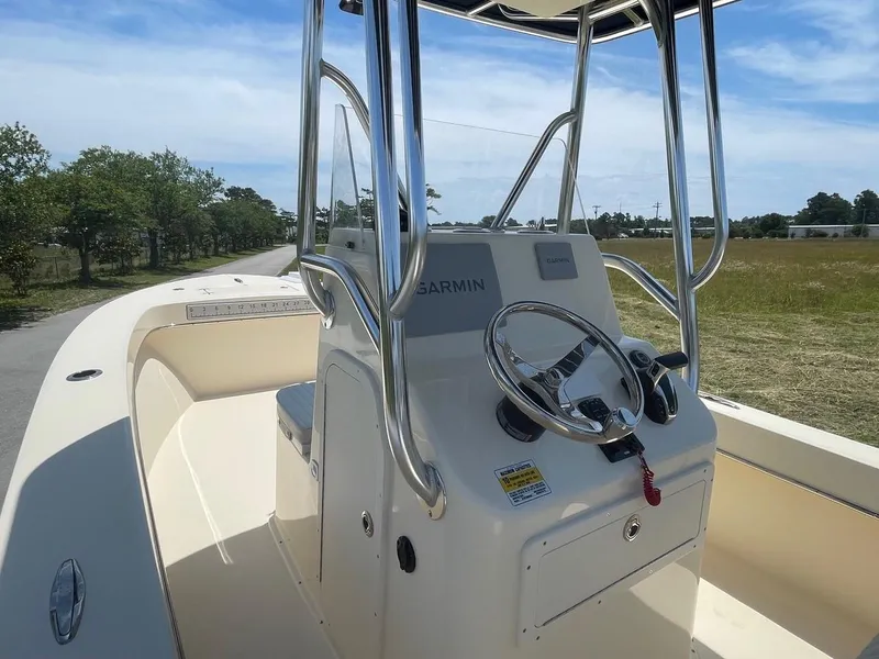 Slide: The Image of 2024 Jones Brothers Cape Fisherman 23 boat on trailer under blue sky. - 21