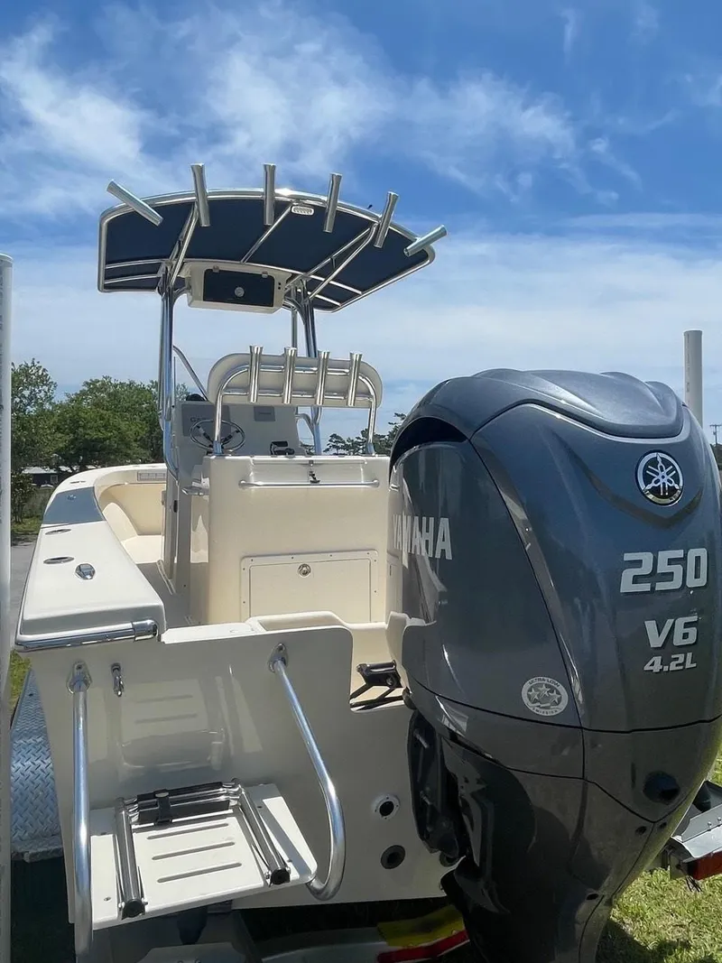 Slide: The Image of 2024 Jones Brothers Cape Fisherman 23 boat with T-top and rod holders. - 23