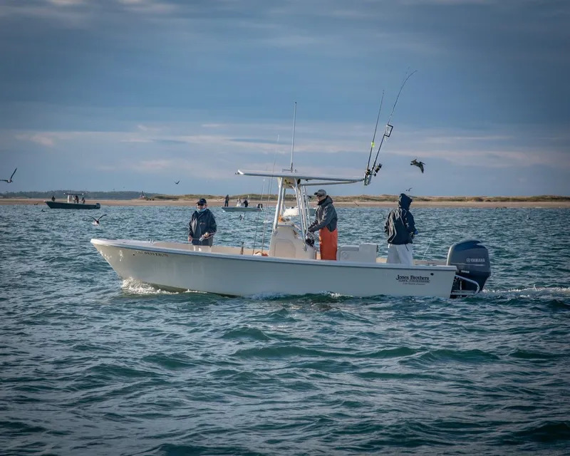 Slide: The Image of 2024 Jones Brothers Cape Fisherman 23 boat cruising on open water. - 8