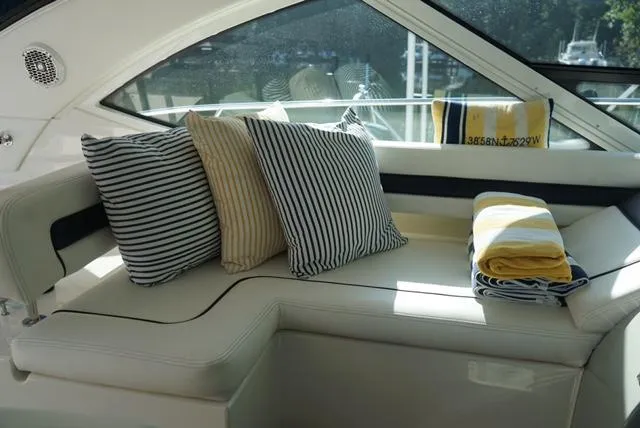 Slide: The Image of Luxurious seating area on 2010 Sea Ray 470 Sundancer with striped cushions and towels. - 11