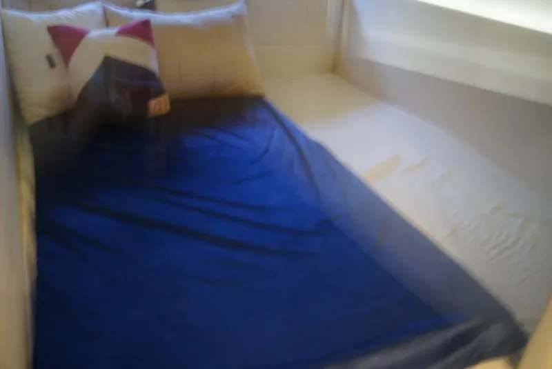 Slide: The Image of Cozy cabin bed with blue blanket in 2010 Sea Ray 470 Sundancer yacht. - 15