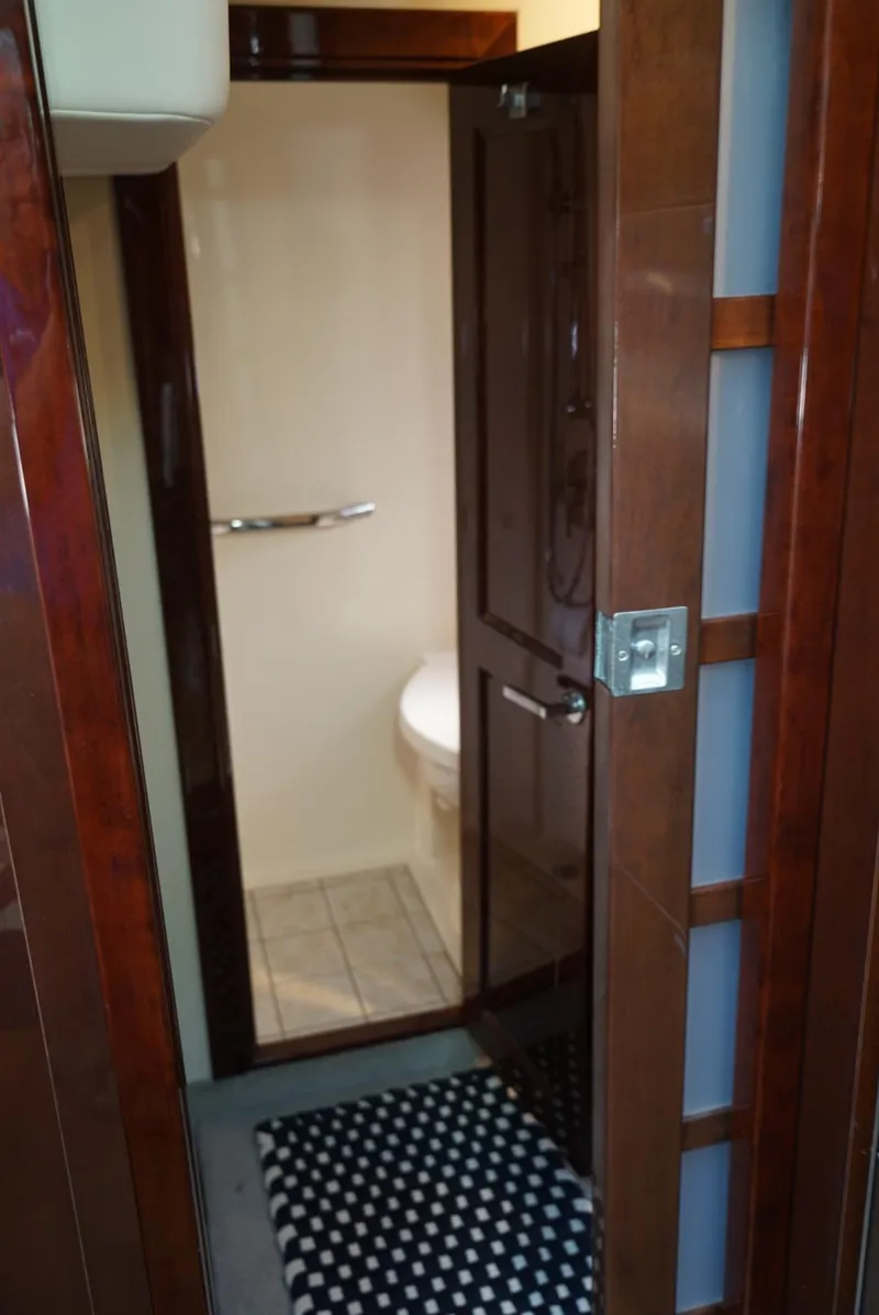 Slide: The Image of Interior bathroom of 2010 Sea Ray 470 Sundancer yacht with wooden door and tiled floor. - 20
