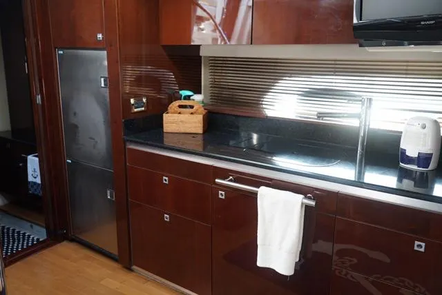 Slide: The Image of Luxurious kitchen interior of 2010 Sea Ray 470 Sundancer yacht with modern amenities. - 21