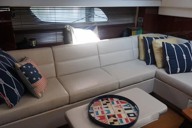 Slide: The Image of Luxurious interior of 2010 Sea Ray 470 Sundancer yacht with plush seating and nautical decor. - 23