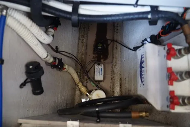 Slide: The Image of Engine compartment of 2010 Sea Ray 470 Sundancer with visible wiring and hoses. - 26