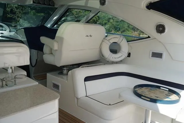 Slide: The Image of Interior of 2010 Sea Ray 470 Sundancer yacht with white seating and helm. - 6