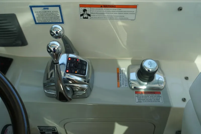 Slide: The Image of Sea Ray 470 Sundancer 2010 helm controls with throttle and joystick. - 8