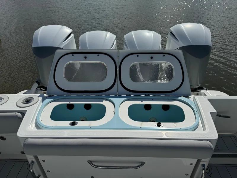 Slide: The Image of 2019 HCB Siesta boat with open livewell and four outboard engines. - 12