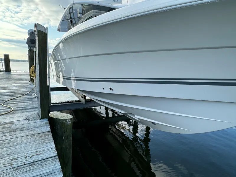 Slide: The Image of 2019 HCB Siesta boat docked at a marina, side view. - 2